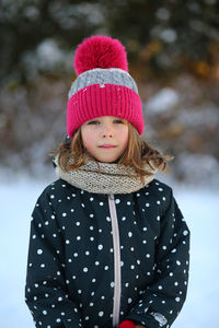 Winter portrait of a girl wearing pompon hat