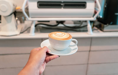 Woman holding coffee cup