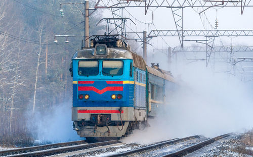 Train on railroad tracks during winter