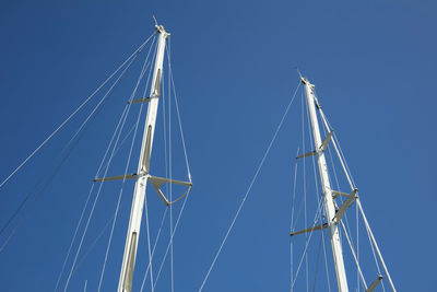 Low angle view of sailboat sailing against clear blue sky