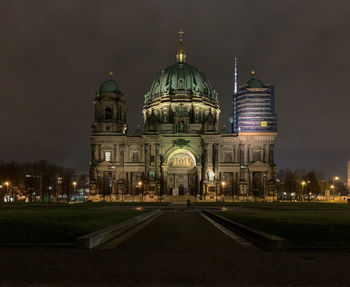 Illuminated building against sky at night