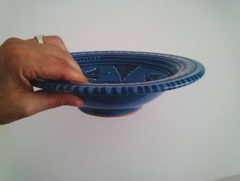 Close-up of cropped hand holding camera