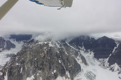 Aerial view of snowcapped mountains against sky