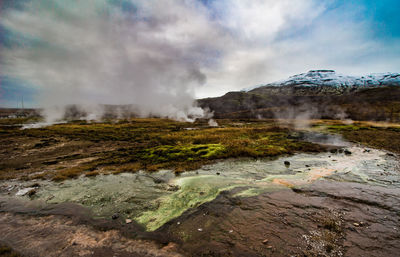 Scenic view of landscape against cloudy sky