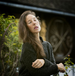 Woman in romantic pose between rustic houses, slovenia iv