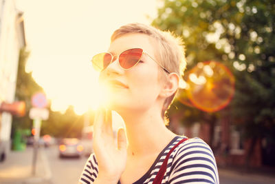 Portrait of young woman wearing sunglasses outdoors