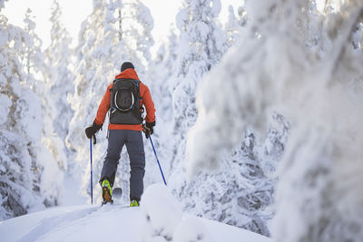 Rear view of man cross-country skiing