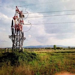 Scenic view of field against cloudy sky