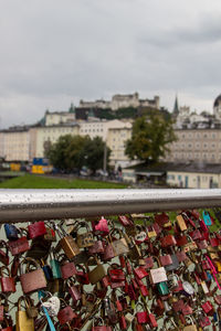 Close-up of padlocks on railing against bridge