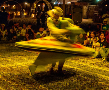 People at street in city at night