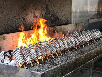 Burning candles on barbecue grill