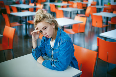 Portrait of young woman sitting at cafe