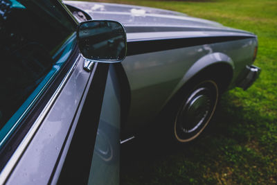 Close-up of vintage car on road