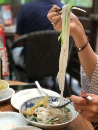 Midsection of woman preparing food in bowl