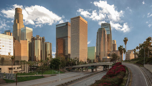 Road amidst buildings against sky in city