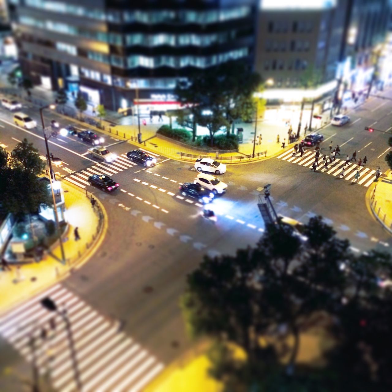 city, transportation, building exterior, car, architecture, mode of transport, built structure, land vehicle, street, traffic, city street, city life, high angle view, on the move, road, illuminated, incidental people, street light, travel, motion