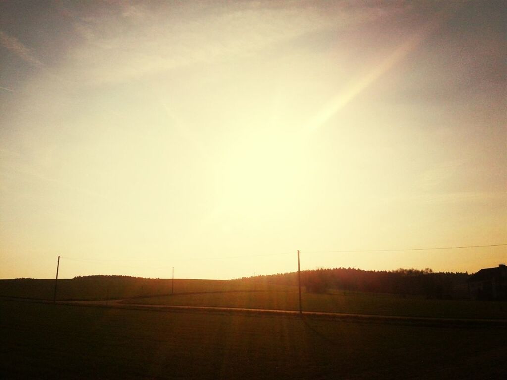 sunset, landscape, field, tranquil scene, tranquility, silhouette, sky, road, scenics, sun, beauty in nature, transportation, nature, rural scene, horizon over land, the way forward, sunlight, copy space, outdoors, country road