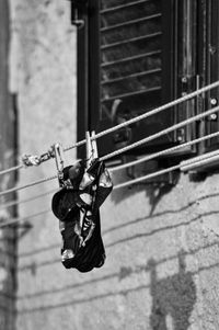 Clothes hanging on rope against wall