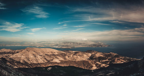 Scenic view of sea and mountains against sky