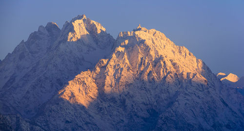 Scenic view of snowcapped mountains against clear sky