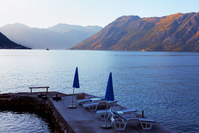 Sun loungers on the pier . calm summer morning at kotor bay