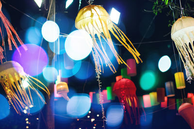 Low angle view of illuminated lanterns hanging at night