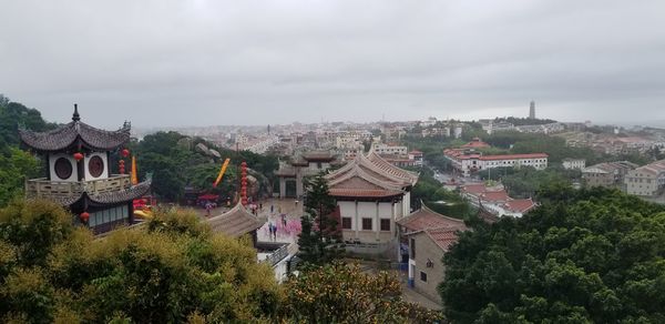 High angle view of trees and buildings against sky