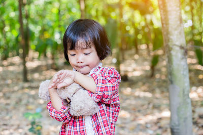 Portrait of cute girl holding outdoors