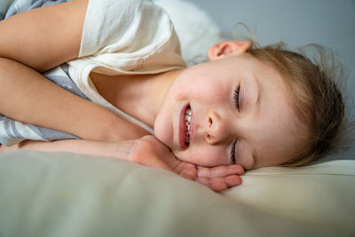 Portrait of cute baby sleeping on bed at home