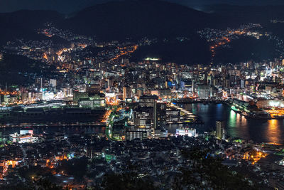 High angle view of illuminated buildings in city at night