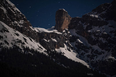 Scenic view of snowcapped mountains against sky at night