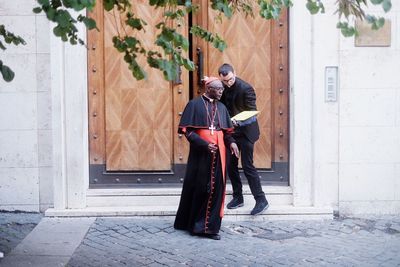 Full length of man and woman standing by door