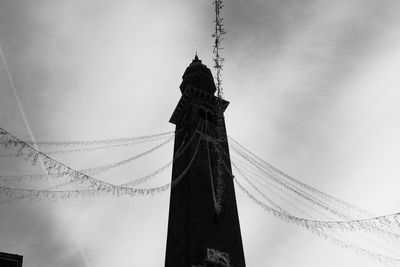 Low angle view of tower against cloudy sky