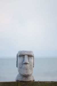 Close-up of statue against sea