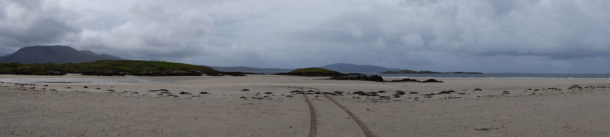 Panoramic view of beach against cloudy sky