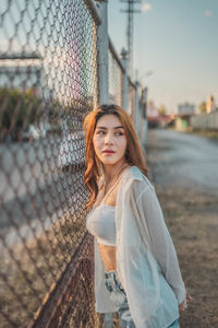 Portrait of beautiful young woman standing outdoors