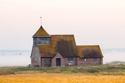 Old building on field against sky