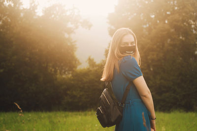 Full length of woman standing on field