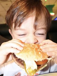 Close-up portrait of boy eating food