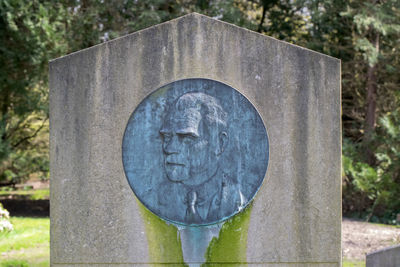 Close-up of stone cross in cemetery