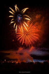 Low angle view of firework display at night