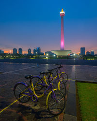 Bicycle by building against sky