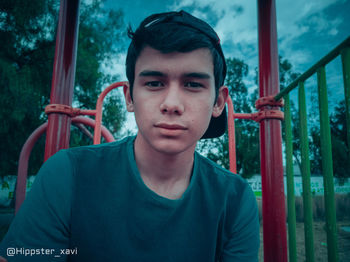 Portrait of teenage boy looking at railing