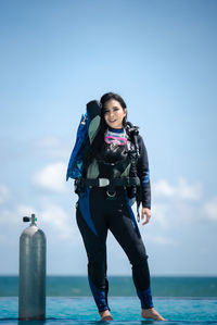 Portrait of woman standing against sea and sky