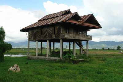 View of barn on field against sky