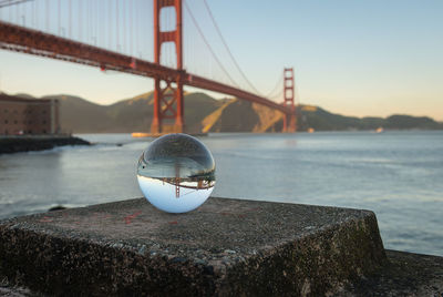 Golden gate bridge over river against sky