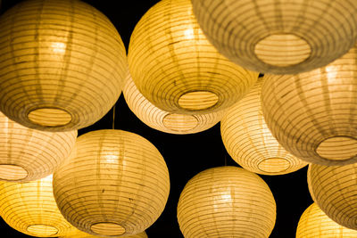 Low angle view of illuminated lanterns hanging at ceiling