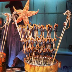 Fried scorpions on skewers at market stall