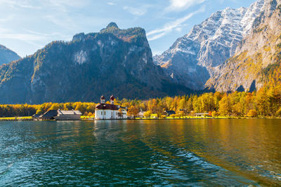 Scenic view of lake by mountain against sky