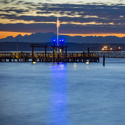 Pier by sea during sunset